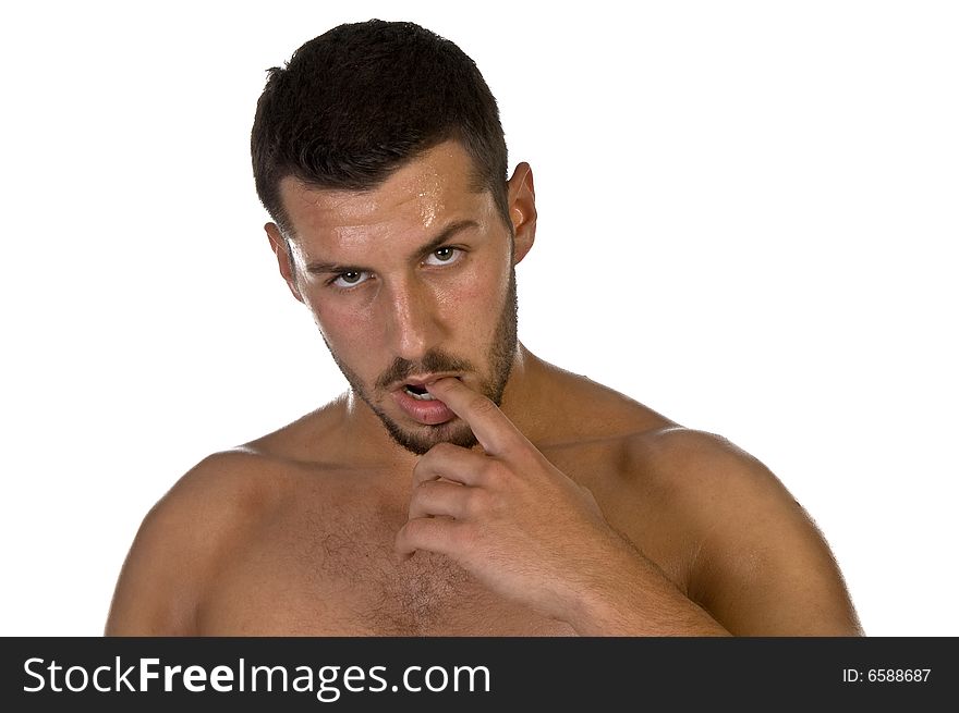 Young male looking with finger in his mouth on an isolated background