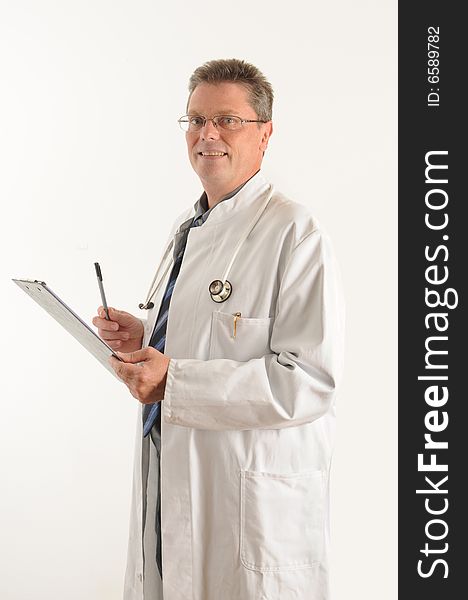 Doctor at the clinic, doing his paperwork on a clipboard. Isolated over white. Doctor at the clinic, doing his paperwork on a clipboard. Isolated over white.