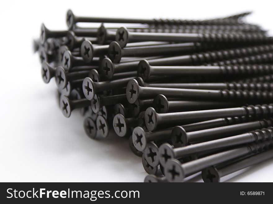 Sundries. Group of iron screws on a white background