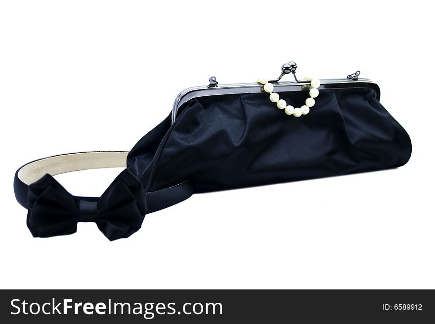 Black bag and pearl bracelet isolated on a white background