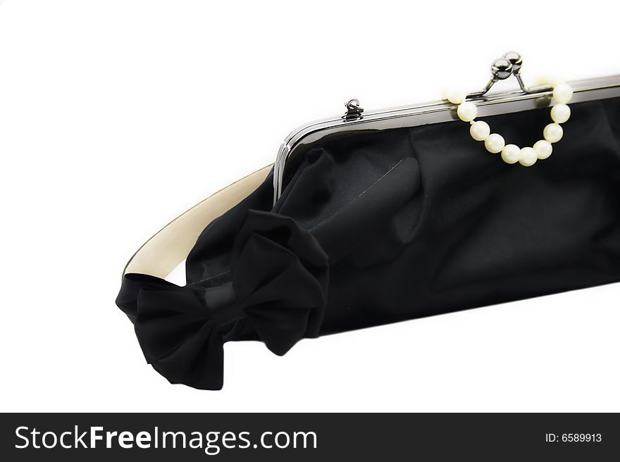 Black bag and pearl bracelet isolated on a white background