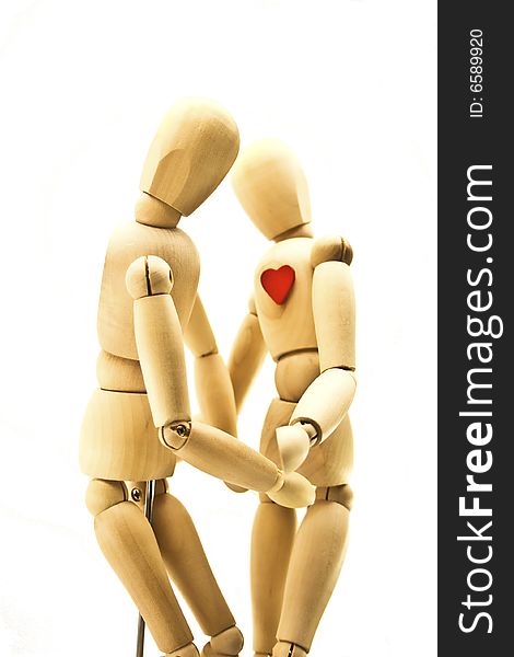 Loving couple of wooden dummies isolated on a white background
