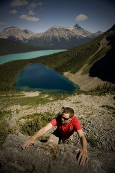 Young Climber Reaches For Handhold In Mountains Royalty Free Stock Images