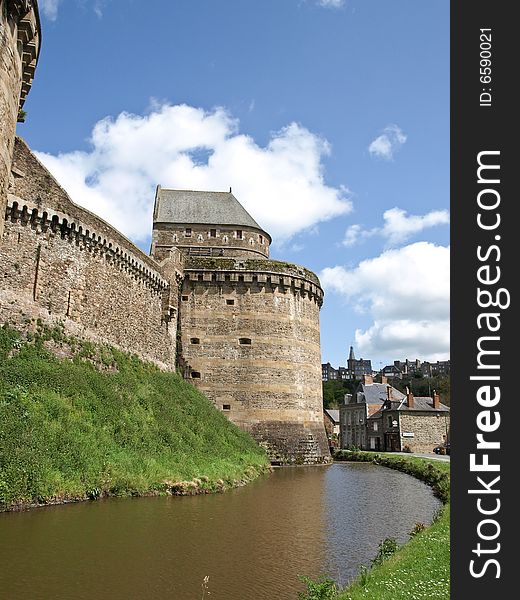 Tower of an ancient castle and protecting ditch with water. Tower of an ancient castle and protecting ditch with water