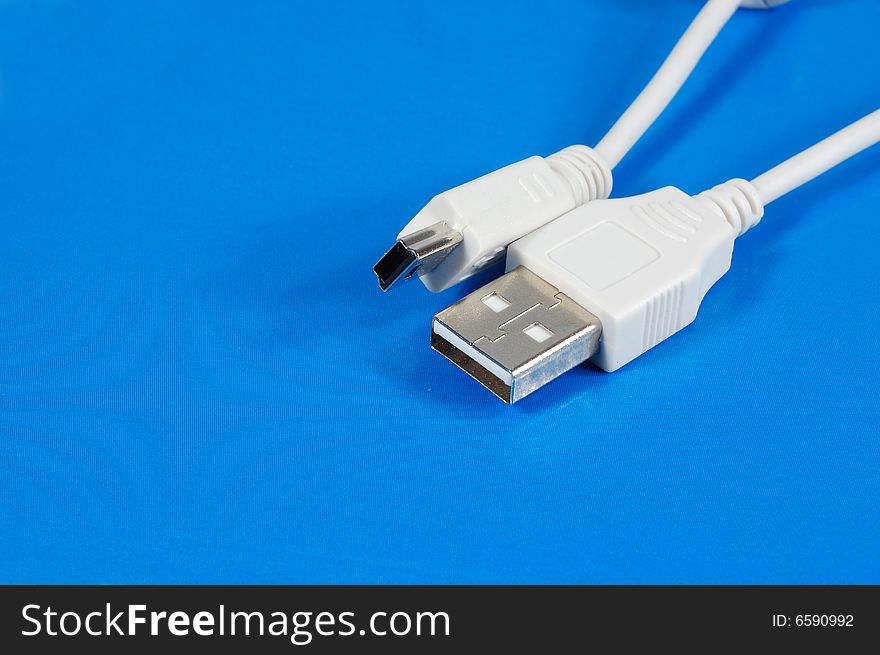 White USB cables isolated on a blue background