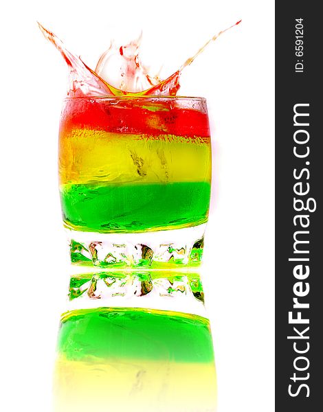 Ice falls in a glass with a colored cocktail. Ice falls in a glass with a colored cocktail