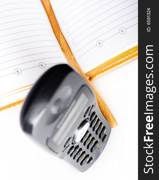 Telephone and notebook isolated on white background