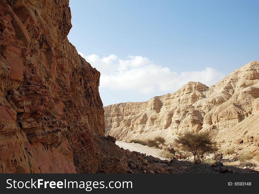 The dried up channel of the river in Judaic mountains near to the Dead Sea. The dried up channel of the river in Judaic mountains near to the Dead Sea