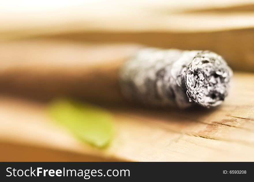 Cigar on wooden  background (shallow DOF)