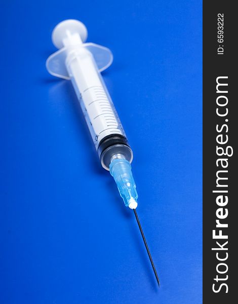 Syringe on blue