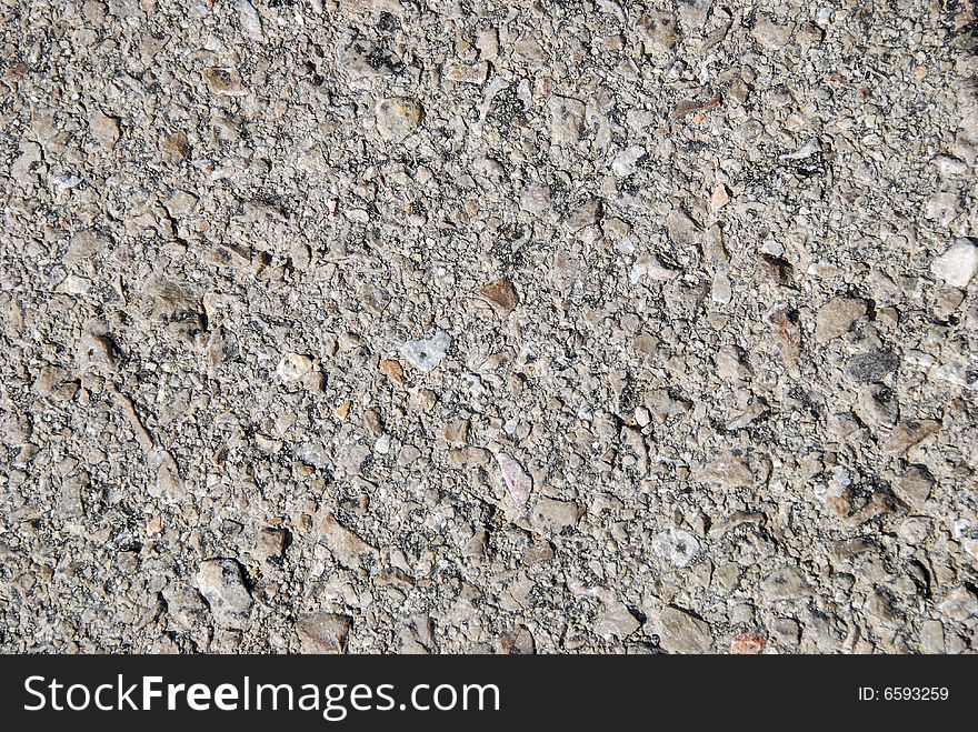 Fragment of old asphalt road close up