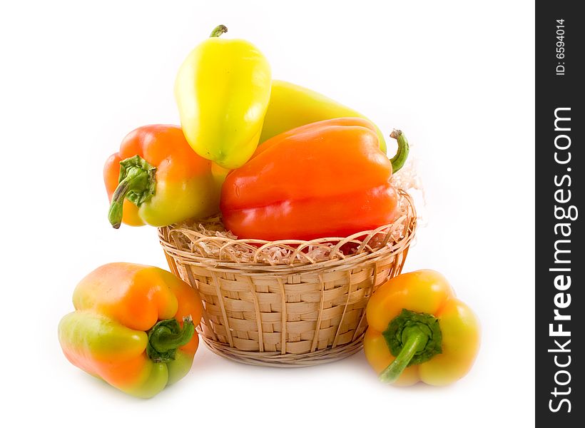 Red green yellow sweet beautiful pepper in basket on white background. Red green yellow sweet beautiful pepper in basket on white background