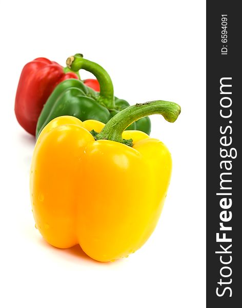 Red, green and yellow bell peppers isolated on white.