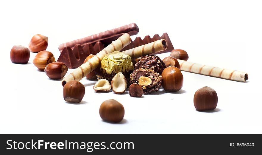 Chocolate and diverse pralines, isolated on white