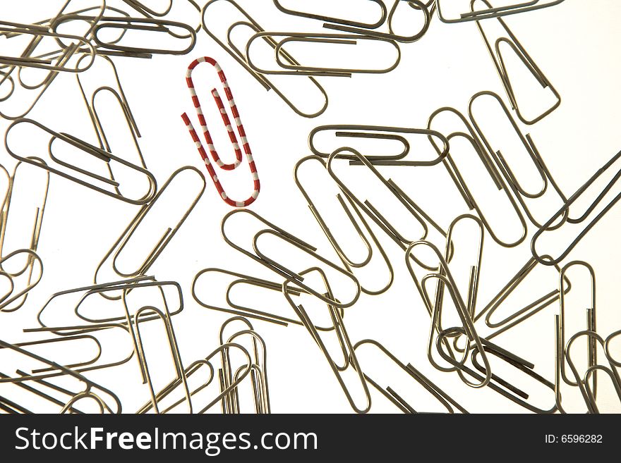 Red And White Paperclip In A Group Of Metal Paperc