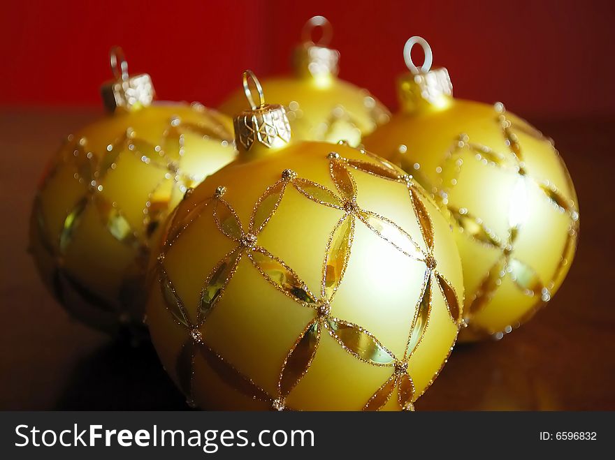 Close-up of golden glass balls on red background. Close-up of golden glass balls on red background