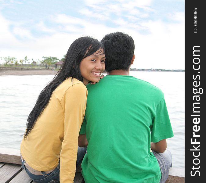 The photograph of happy asian couple on pier looking to bright future