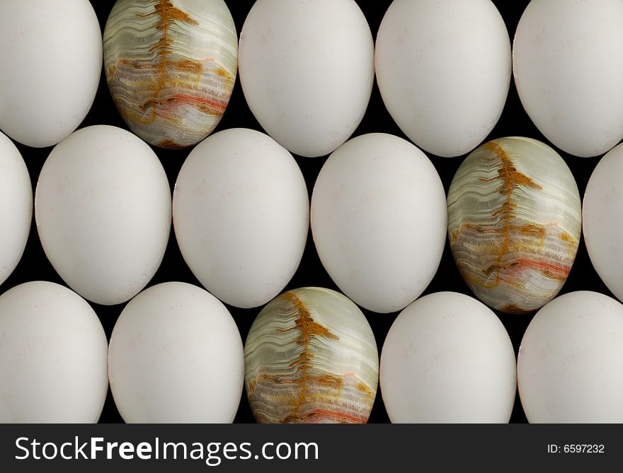 Three gem eggs among white chicken eggs. Three gem eggs among white chicken eggs