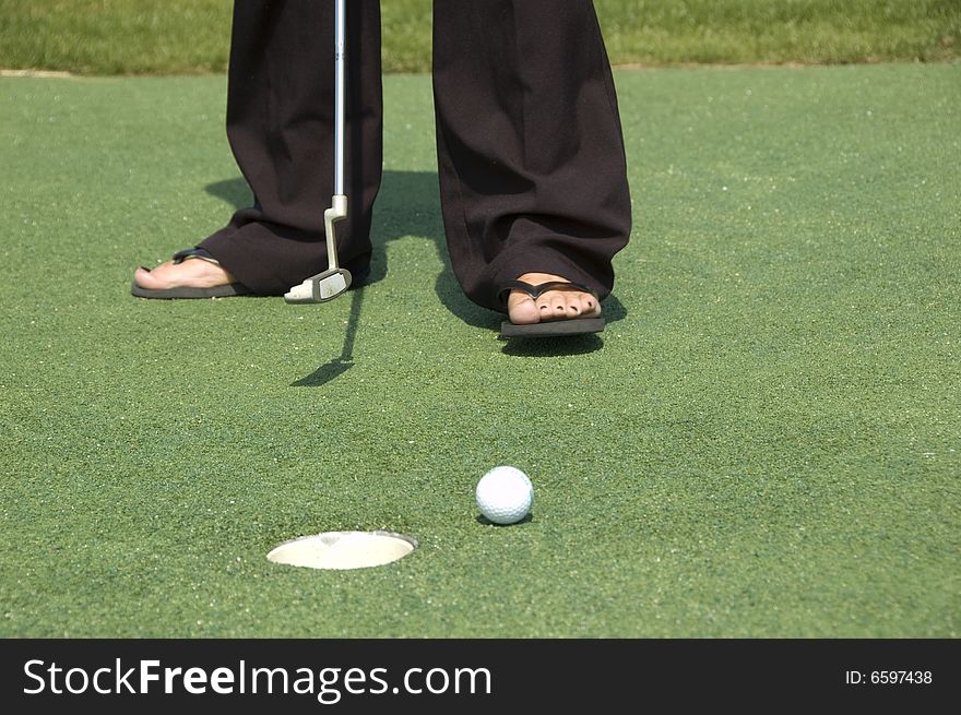 A woman wearing sandals playing golf. A woman wearing sandals playing golf