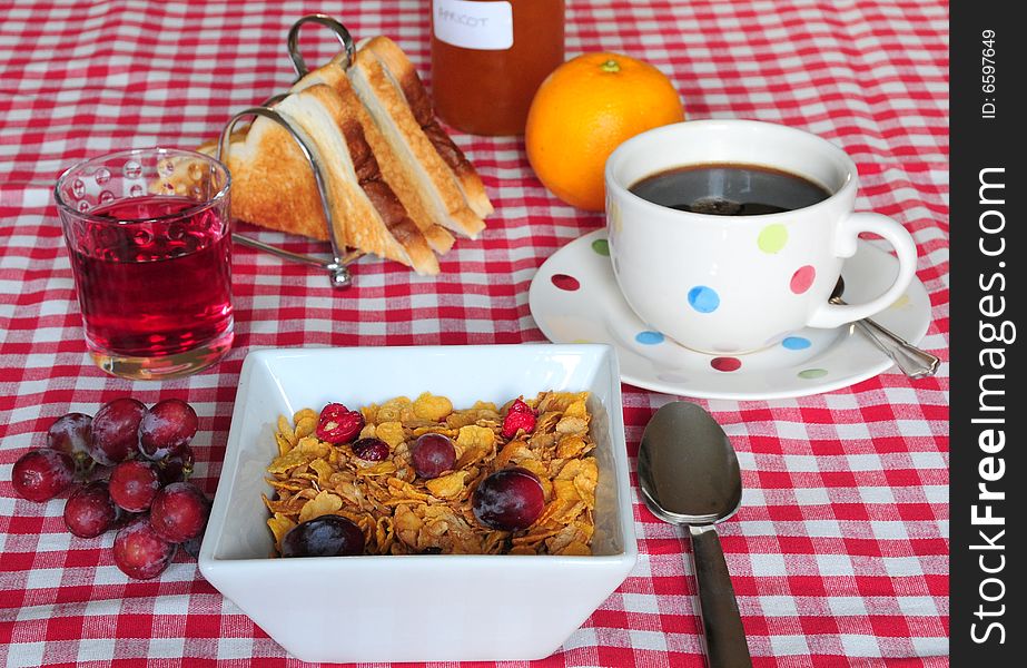 Breakfast items on a red and white tablecloth