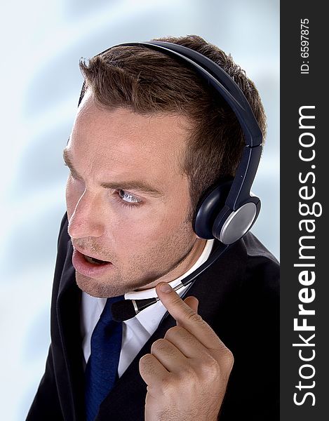 Potrait young businessman with headphones on an abstract background