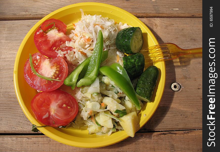 A salad from fresh, tasty, many-coloured vegetables on the plate. A salad from fresh, tasty, many-coloured vegetables on the plate.