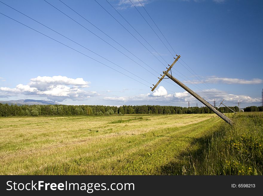 Rural landscape; falling telegraph poles