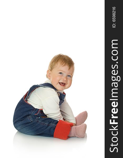 Small smiling baby in blue jeans isolated