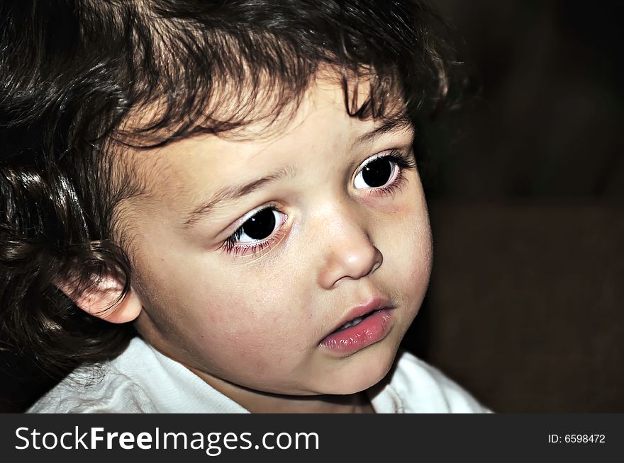 Little girl with big brown eyes and curly hair close-up. Little girl with big brown eyes and curly hair close-up