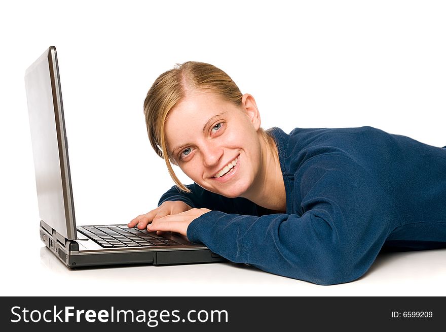 Detail of an happy cute blondie girl on a laptop computer looking at camera, isolated on white background. Detail of an happy cute blondie girl on a laptop computer looking at camera, isolated on white background