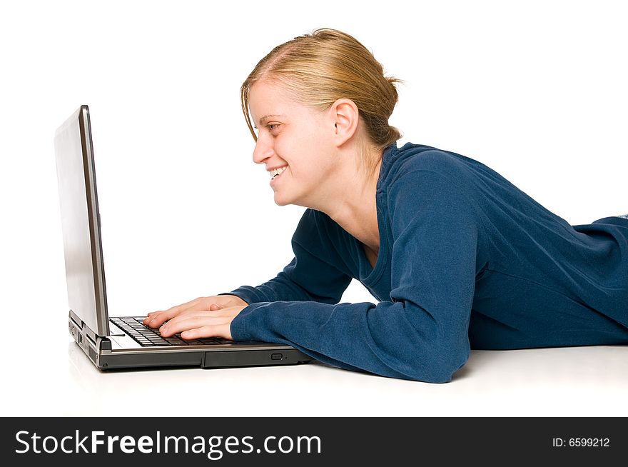 Happy cute blondie girl enjoying her time on a laptop computer isolated on white background. Happy cute blondie girl enjoying her time on a laptop computer isolated on white background