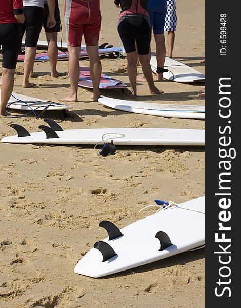 Surfers on the Beach with their Boards