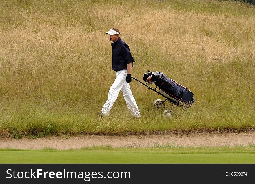 Golf player walking with his club bag. Golf player walking with his club bag