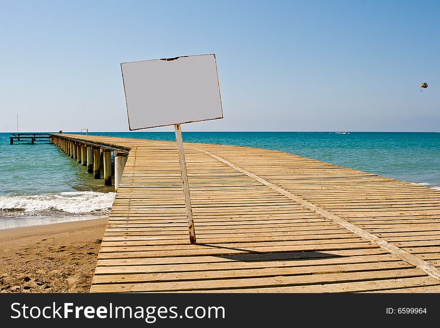 Mooring with an information board on a background of the blue sky