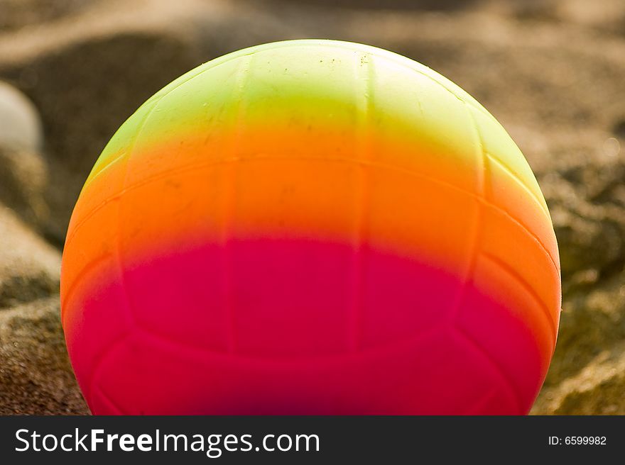 Children's multi-coloured ball on sand