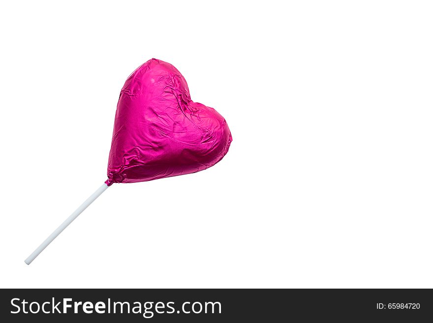 Close up of chocolate heart-shaped lollipop on white background