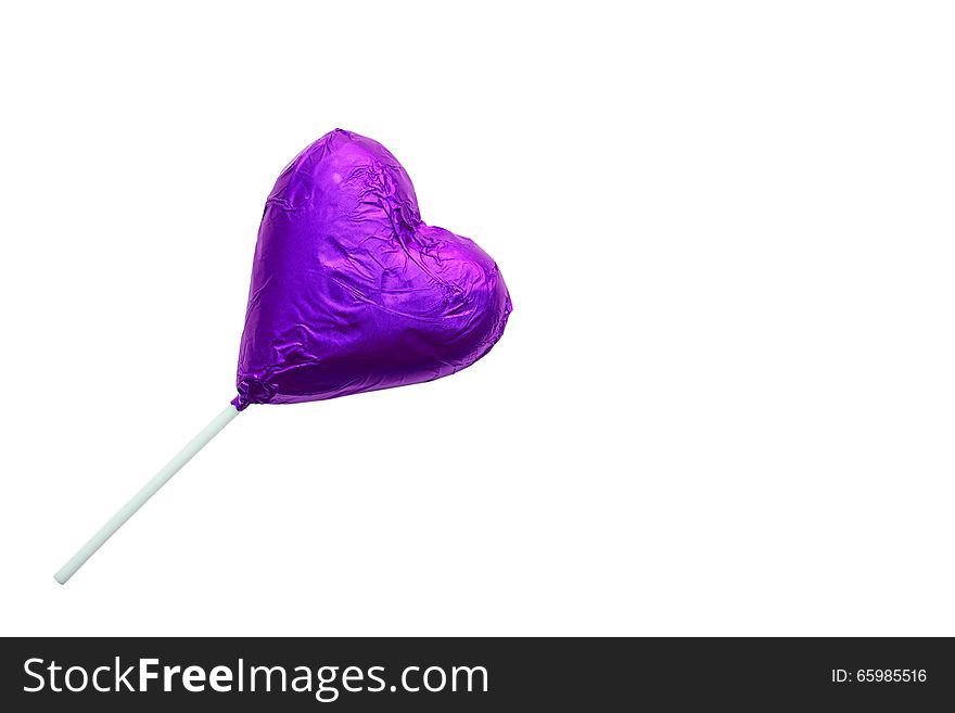 Close up of chocolate heart-shaped lollipop on white background