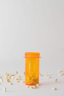 Pills In And Around Medicine Bottle Royalty Free Stock Photography