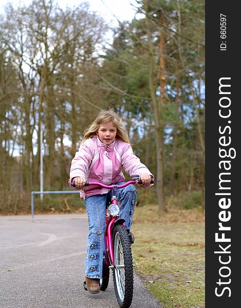 Young Girl On Her Bike