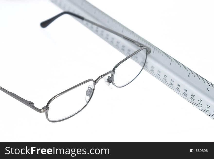 Reading eyeglasses and ruler on table