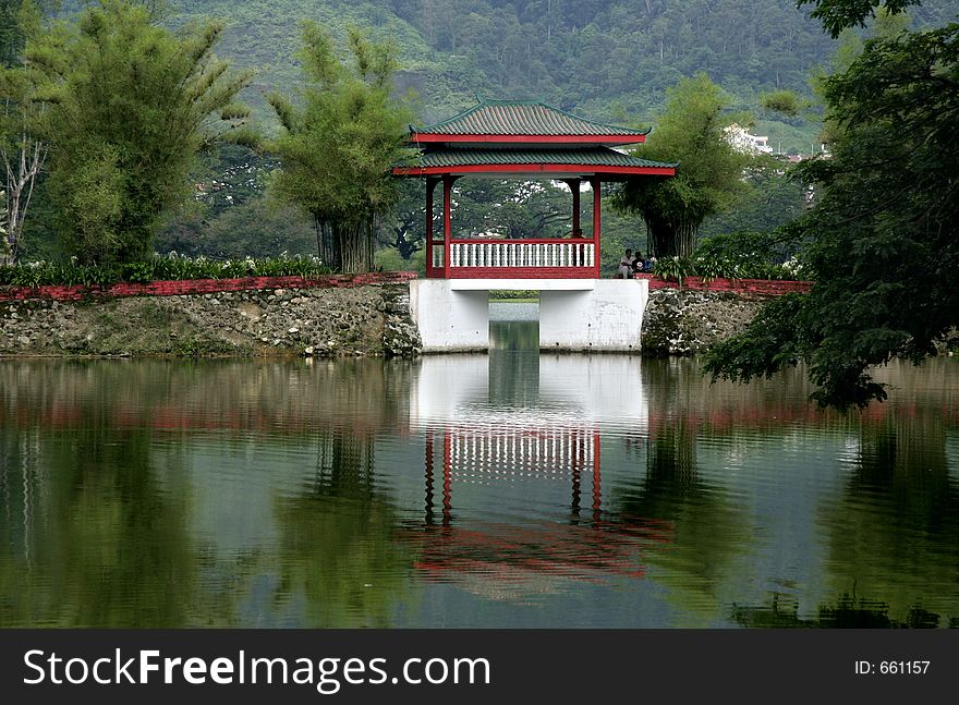 Reflections on the lake of a bridge with Chinese architecture. Reflections on the lake of a bridge with Chinese architecture