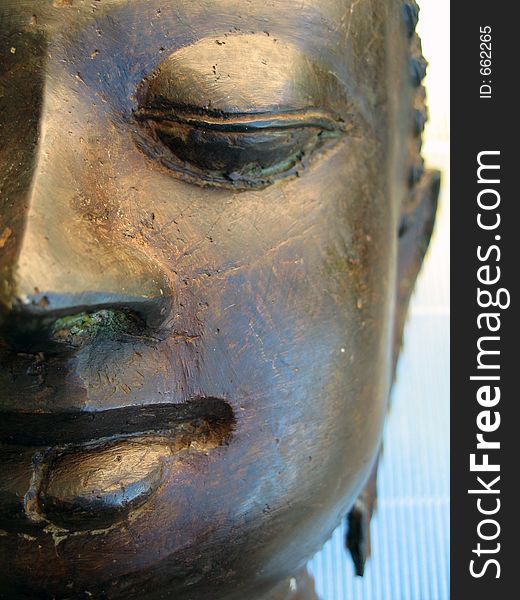 A bronzed sculpture of Buddha’s face. A bronzed sculpture of Buddha’s face.