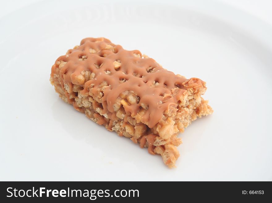 Half eaten snack bar on a white background