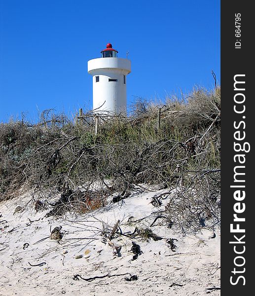 Portrait shot of a coastal dune with lighthouse. Portrait shot of a coastal dune with lighthouse.
