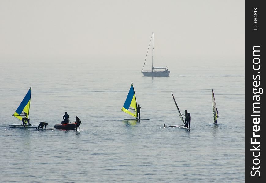 Windsurfers and a boat. Windsurfers and a boat