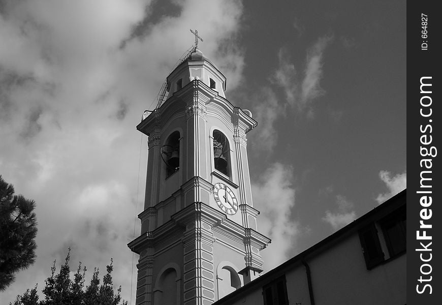 Clock Tower of a catholic church in a cloudy day. Clock Tower of a catholic church in a cloudy day