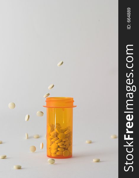 Pills falling into and around medicine bottle version 3