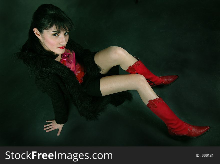 Young woman in red cowboy boots, shot from above. Young woman in red cowboy boots, shot from above