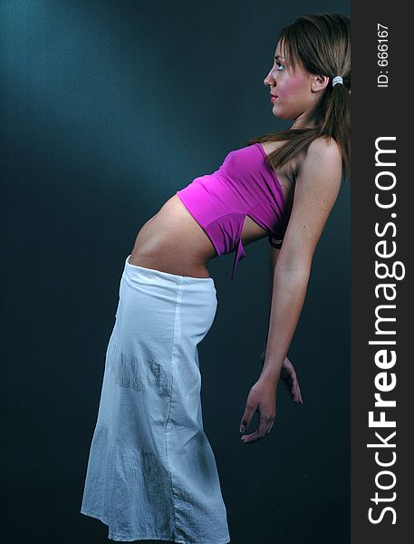 young dancer leans back on the wall highlighting her kinky pierced belly. young dancer leans back on the wall highlighting her kinky pierced belly
