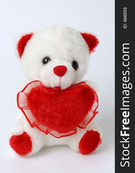 Cute white teddy bear with a red heart. Cute white teddy bear with a red heart